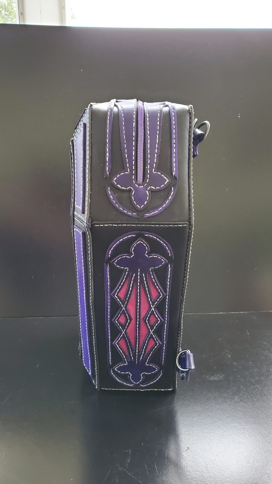 Coffin backpack top and zipper